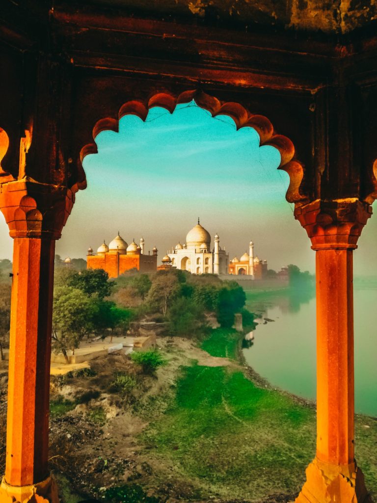 A student traveler framed the Taj Mahal with another building's pillars in Agra, India, in this academic tours program.