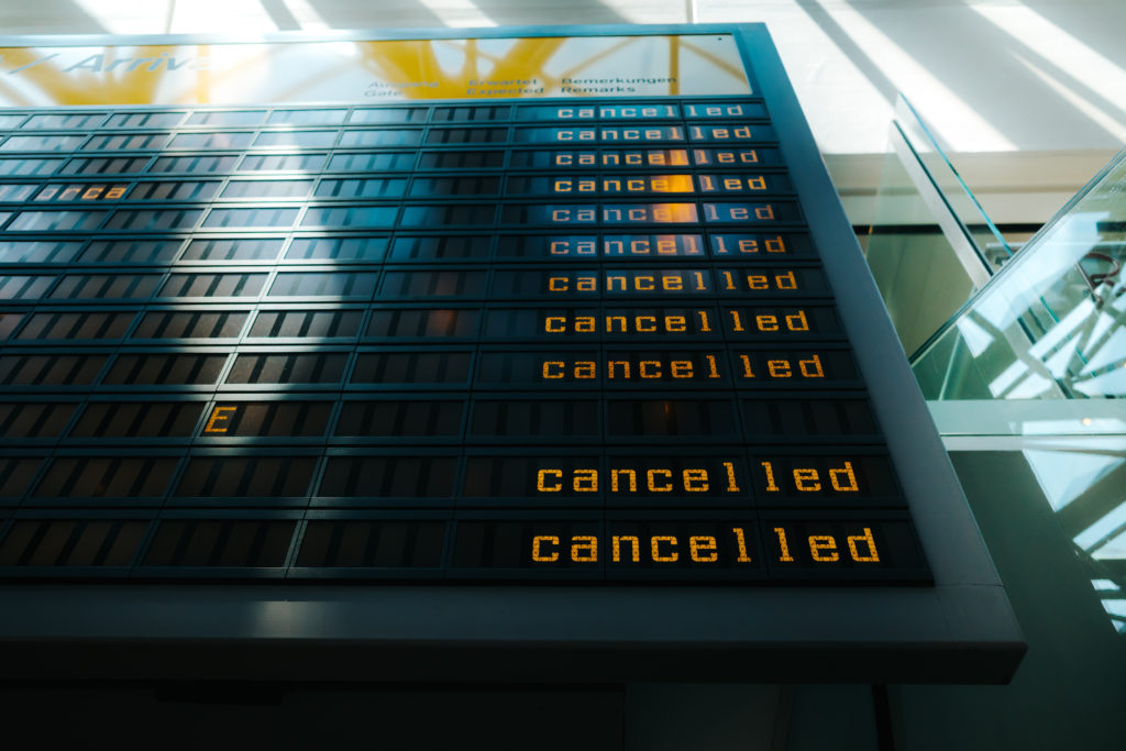 A huge panel of flights at the airport all read cancelled, and those fliers without travel insurance will be left paying large fees and waiting longer than students with it. This image is used in the Students Fare travel blog, "the ultimate travel insurance 101 guide," which describes travel insurance, its importance, and the various insurance options available.