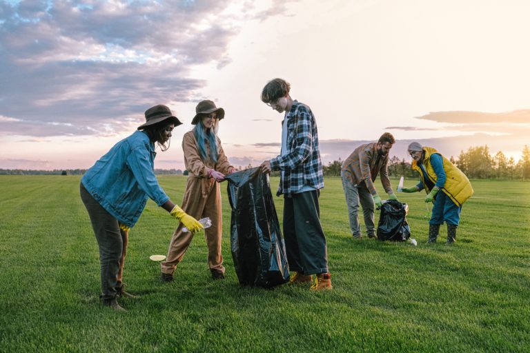 Featured in What Is A Volunteer Trip by Students Fare, this image shows a group of young student volunteers cleaning up trash.