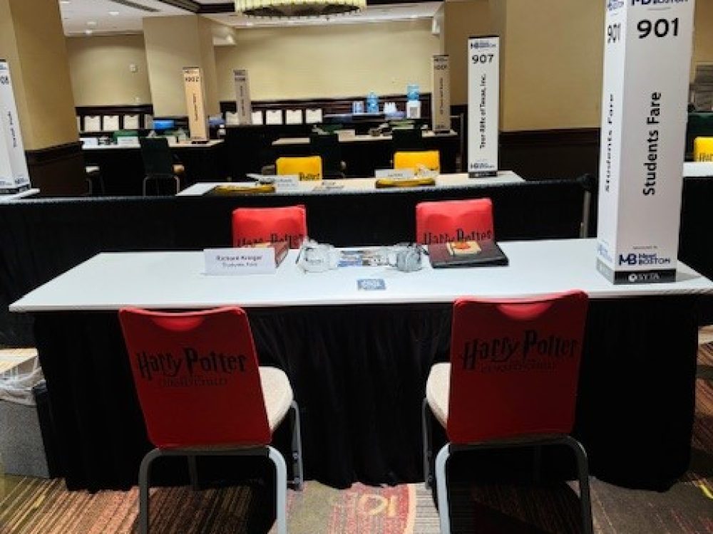 The table setup at the 2024 SYTA event for Students Fare to discuss flights, tours, hotels, and academic pursuits.
