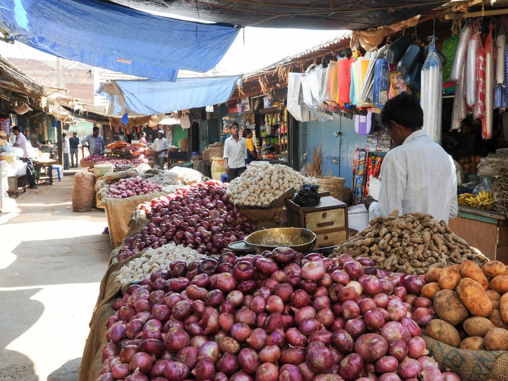 Indian vendors and customers in the Devaraja vegetable market at Mysore, India.